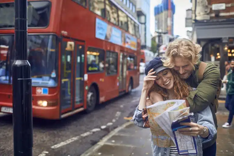 Young couple with a city map doing a city trip